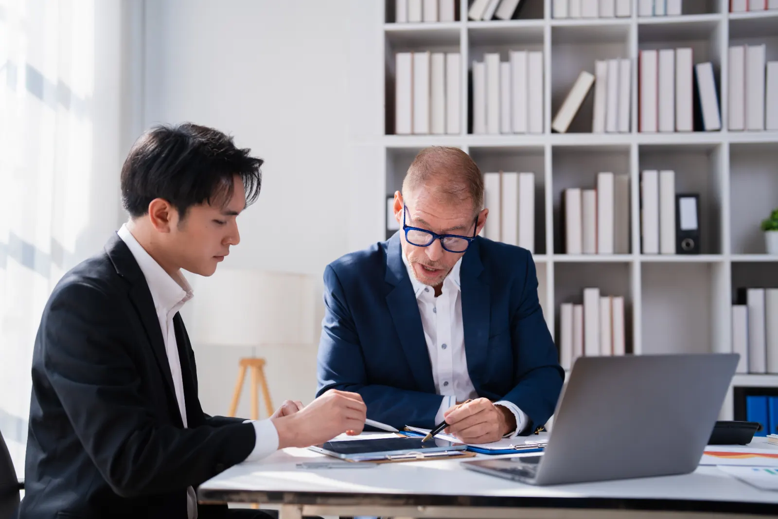HR leader and manager reviewing sexual harassment prevention and reporting documentation