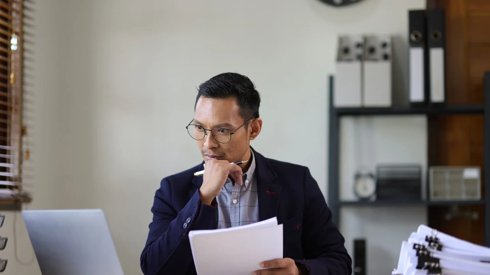 Senior workplace adviser reviewing an investigation report and supporting documents