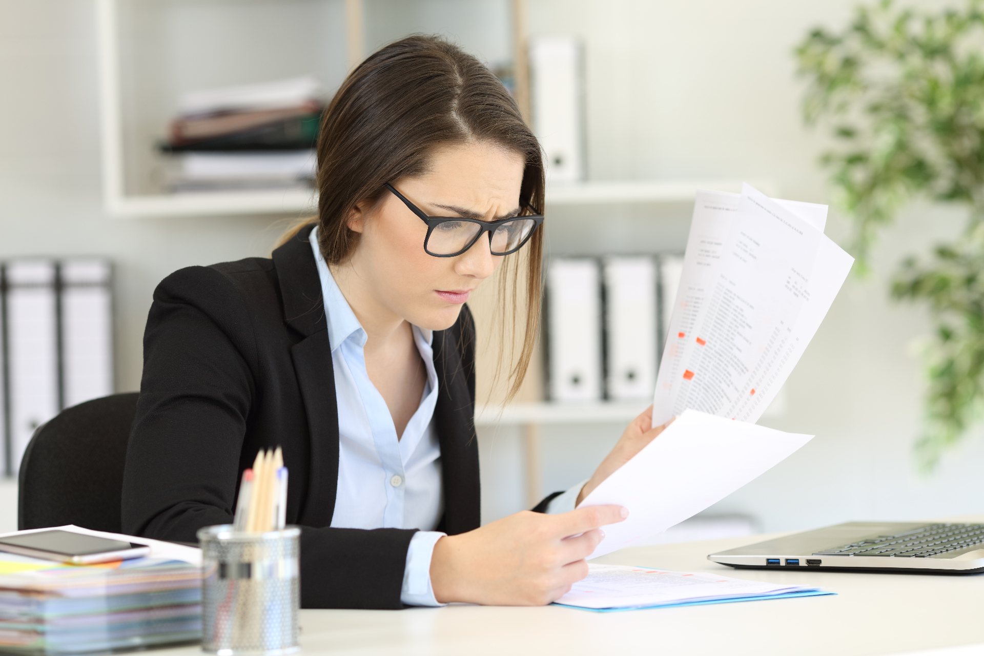 Payroll officer reviewing wage compliance records and employment documents