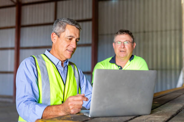 WHS specialist reviewing management-system documentation with an operations leader