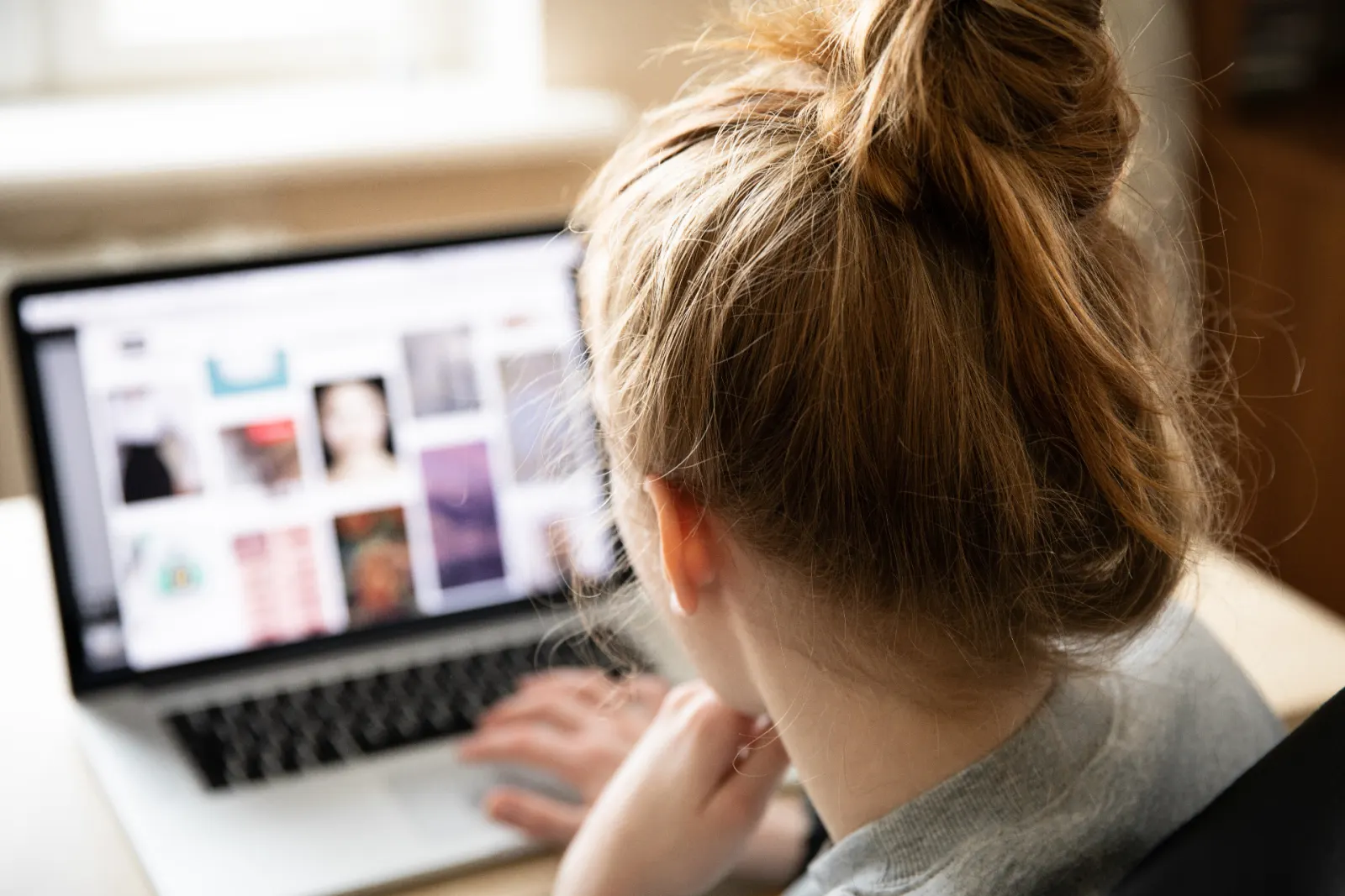 HR leader reviewing employee social media activity on a laptop