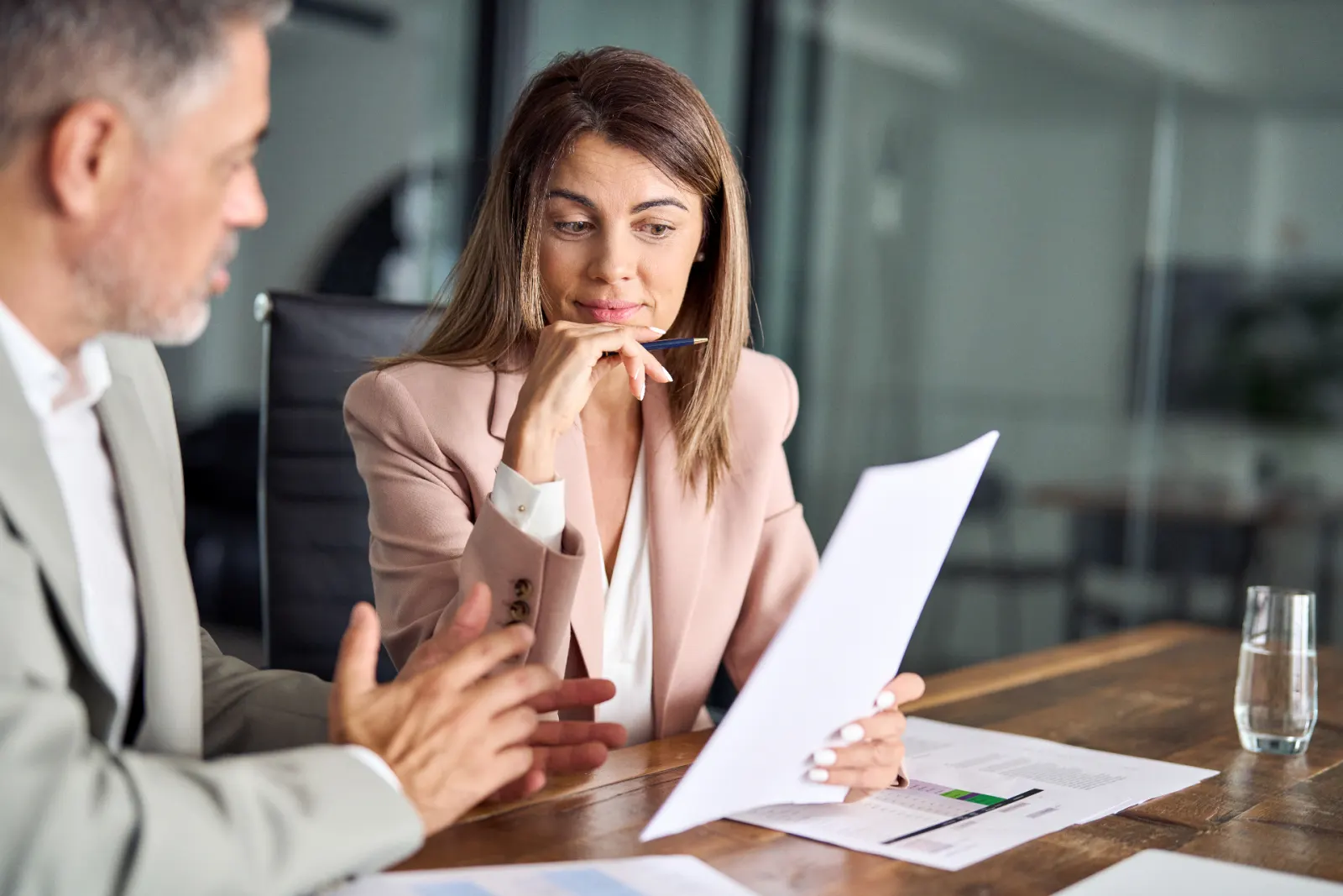 Payroll professional and external adviser reviewing wage compliance documentation