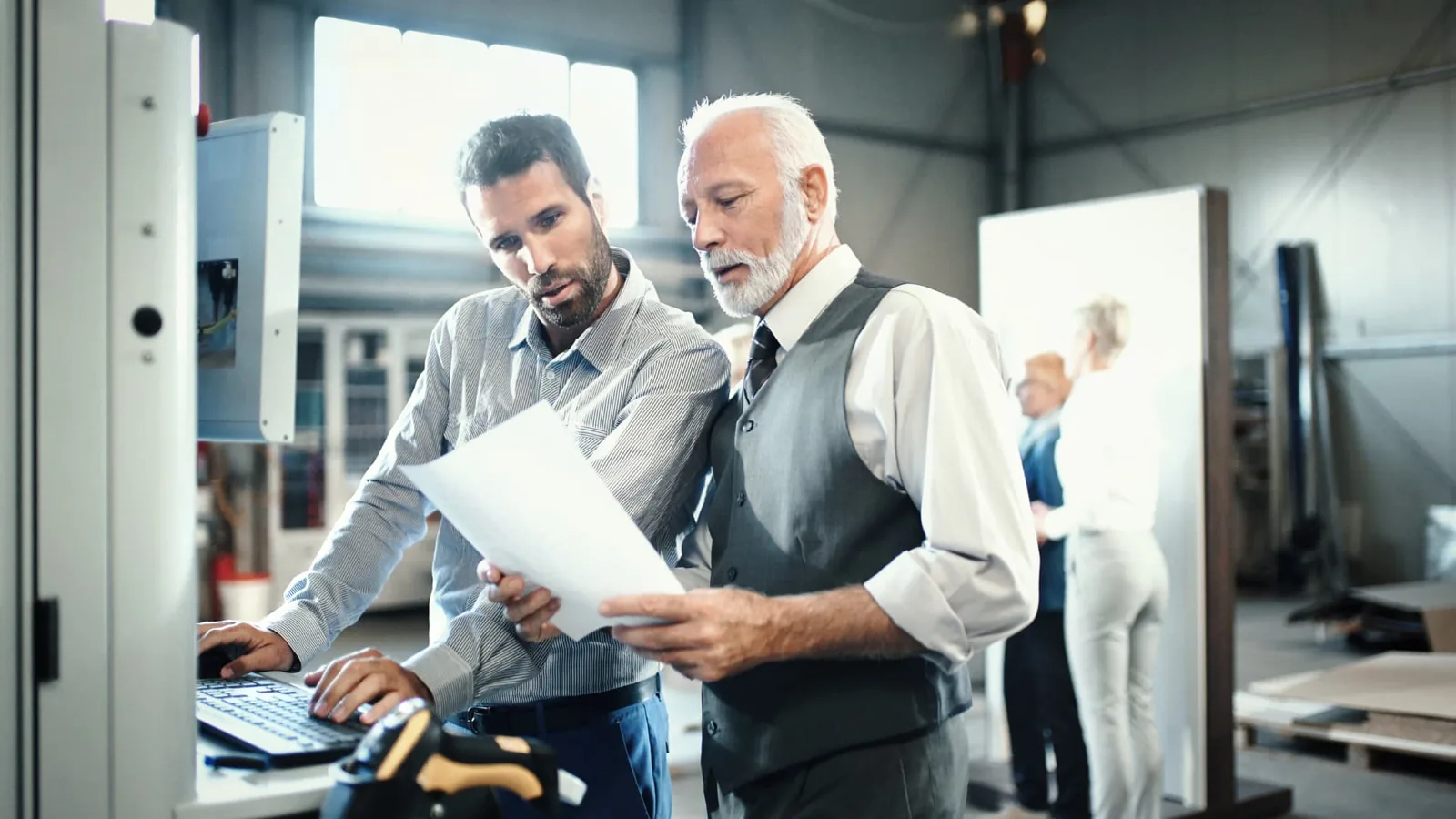 Business owner and independent contractor reviewing a service agreement in an office